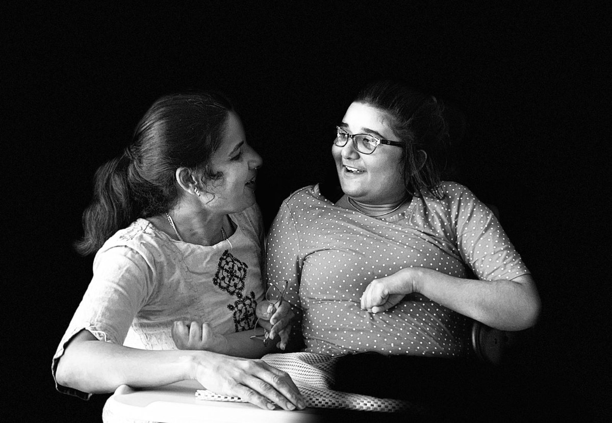 Srinidhi and her mother Sumathi sitting together, turned towards each other and laughing
